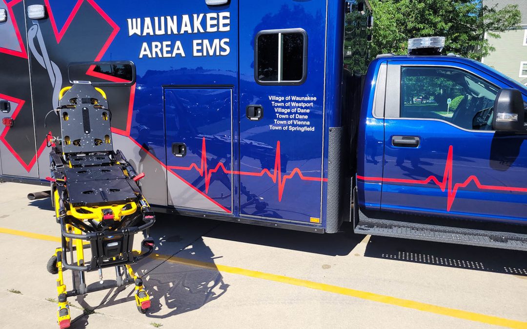 Image of a Hinckley Medical OneWeight patient scale in front of a Waunakee Area EMS ambulance.